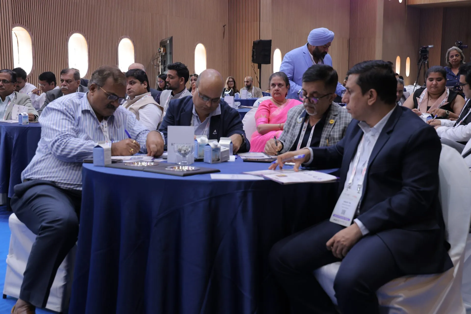 Delegates seated at tables during an EDEC 2026 session